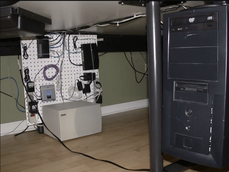 electronics pegboard mounted under desk