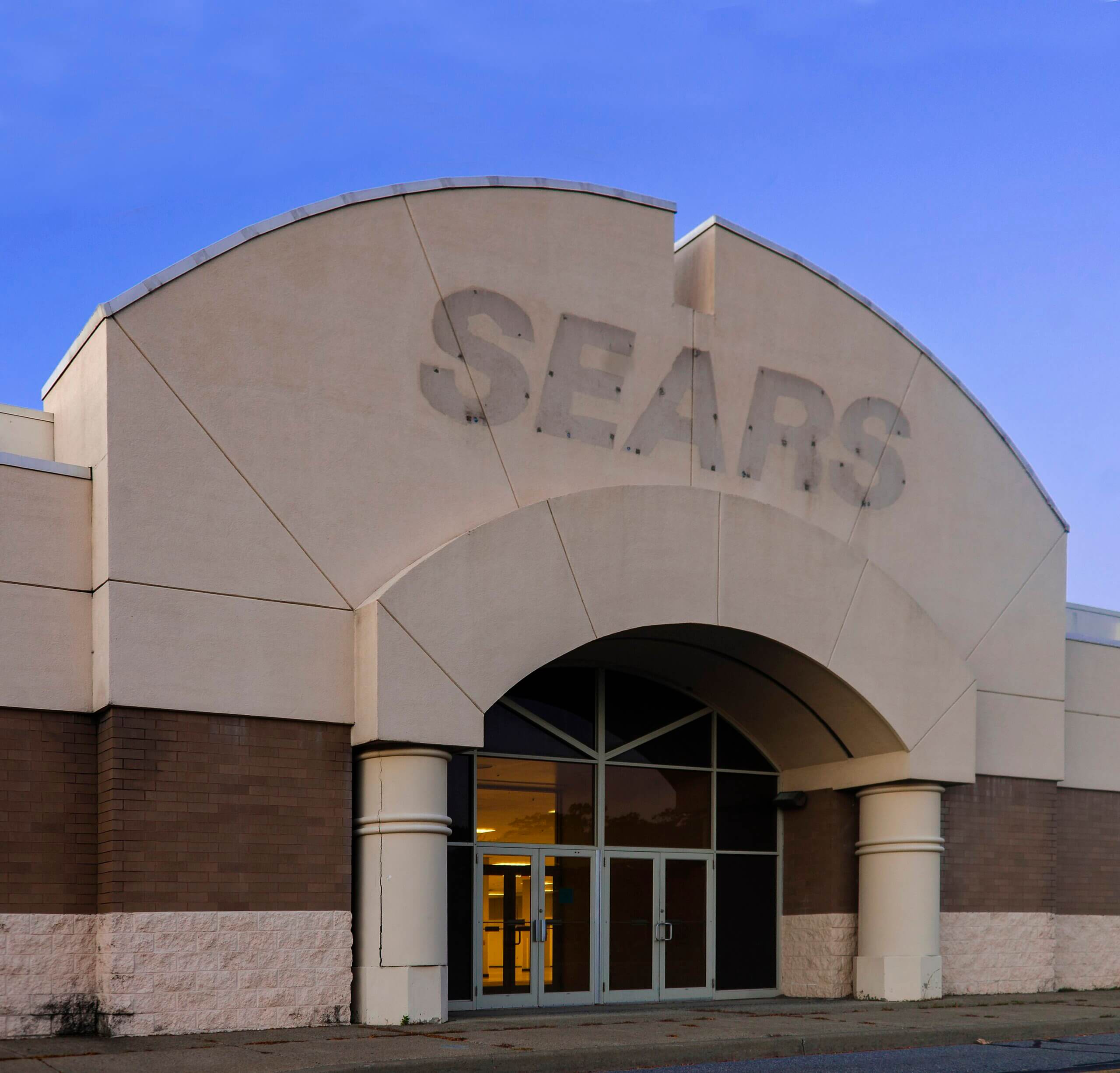 Label scar of sign above entrance to a former Sears store, at the Hudson Valley Mall outside Kingston, NY