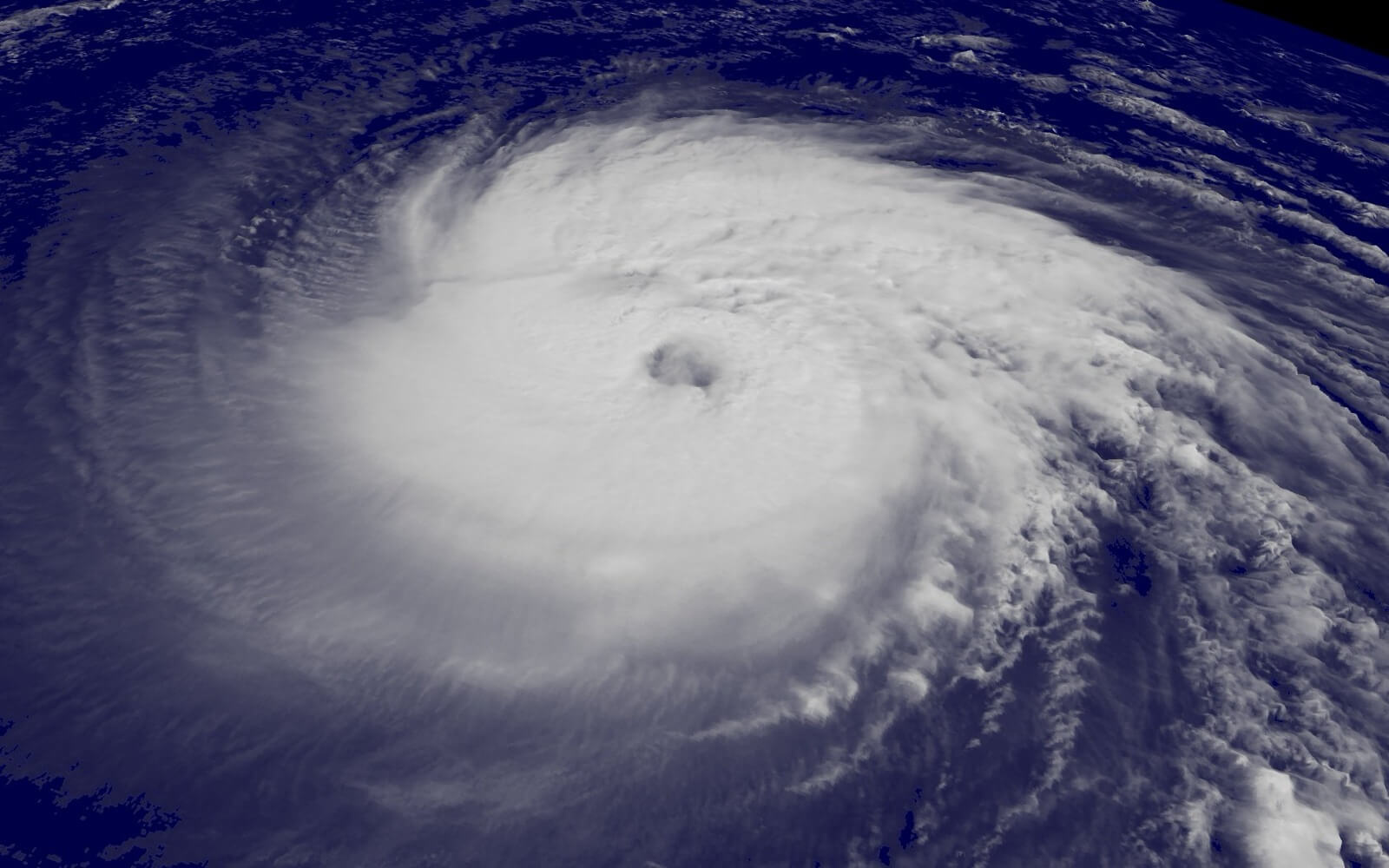 Satellite view of a large, well-organized hurricane with a clear eye spinning over the open Atlantic Ocean